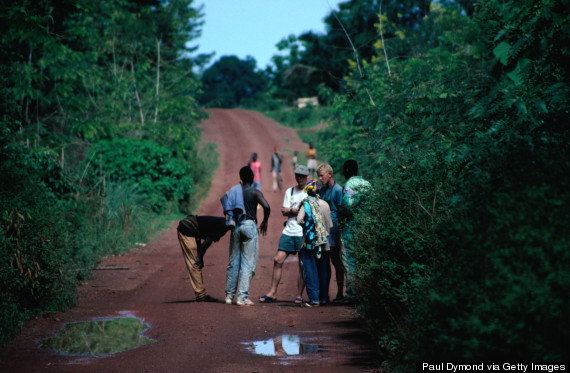 A group of tourists talking with locals on the road from Bangui to Kembe Falls.