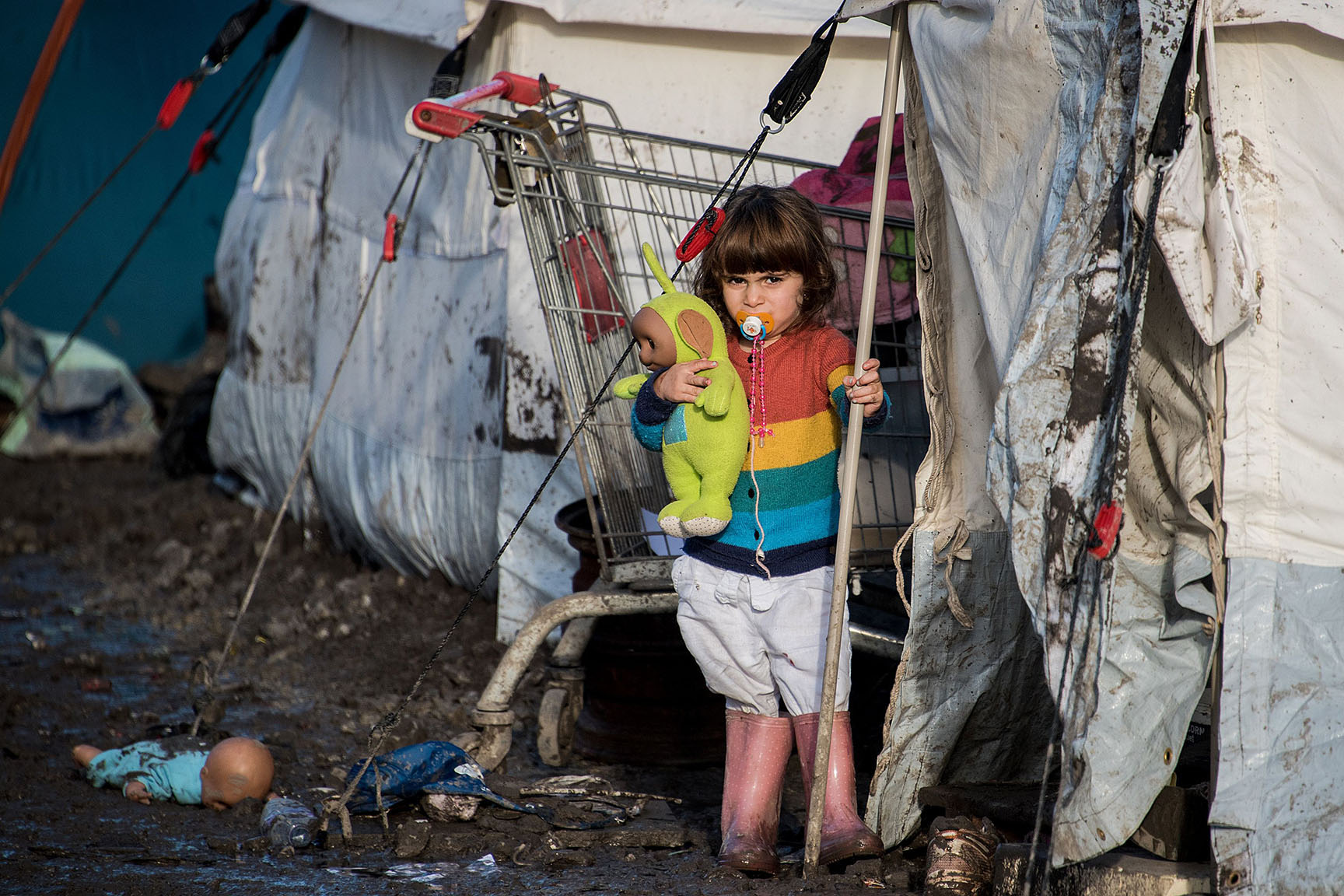 TOPSHOT - The child of Kurdish migrants stands outside a tent at the Grande Synthe migrant camp near Dunkerque in northern France on December 23, 2015. More than 2,000 migrants, mostly Iraqis and Kurds, live in the camp. The UN refugee agency and the International Organization for Migration (IOM) said this week more than one million migrants and refugees reached Europe this year, most of them by sea, more than four times the figure for 2014. / AFP / DENIS CHARLETDENIS CHARLET/AFP/Getty Images